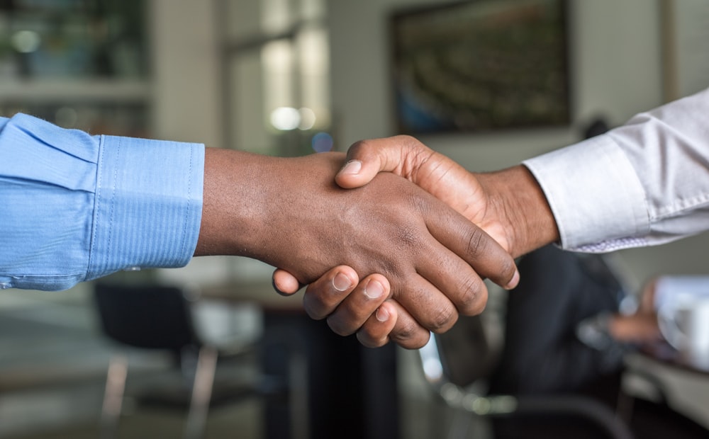 Two professionals shaking hands after a business meeting
