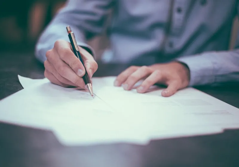 Hand writing on printed company papers during the Dynagest documentation review